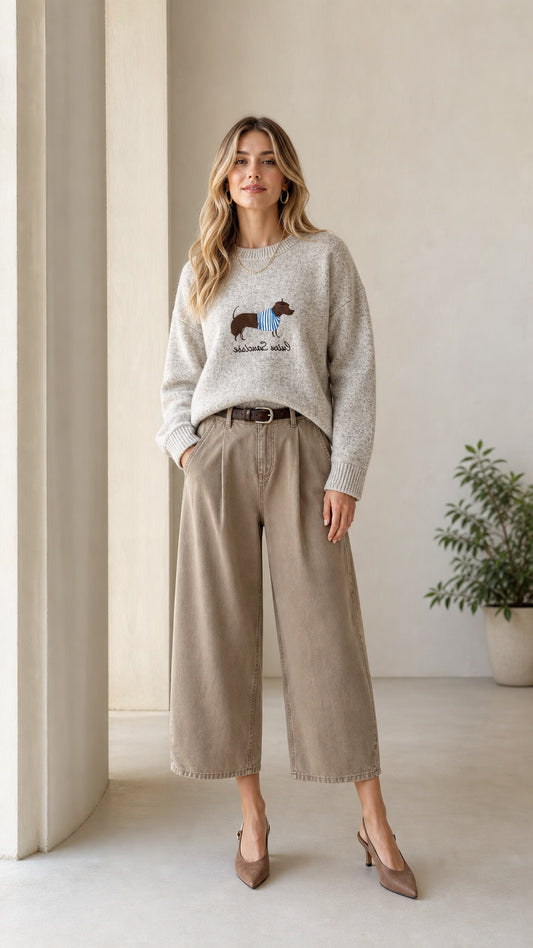 Full front view of model wearing Heather Grey dachshund embroidered sweater with wide-leg trousers