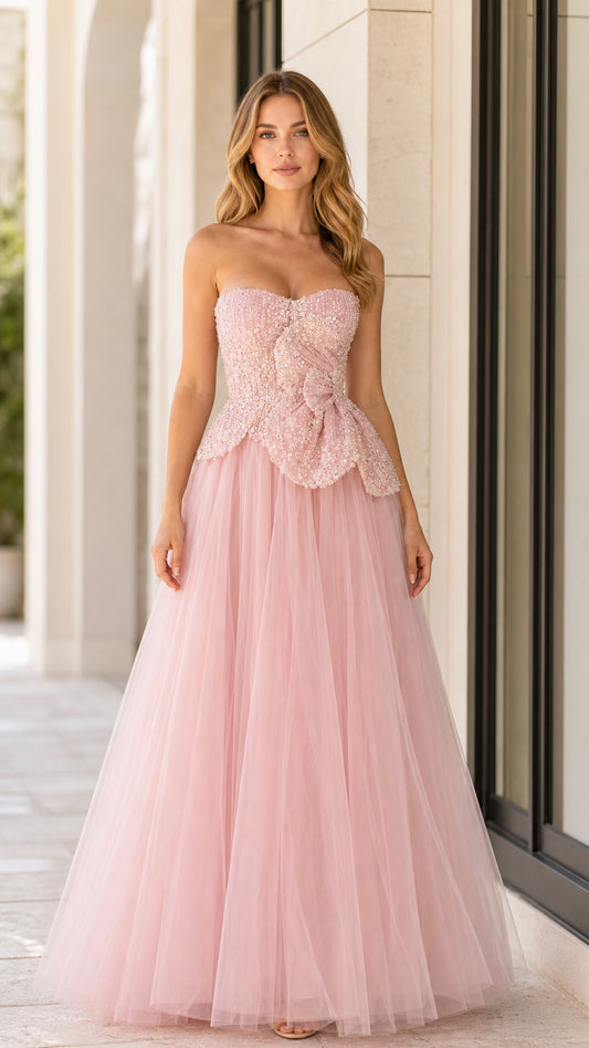 Front full-length view of woman in blush pink strapless beaded tulle ball gown